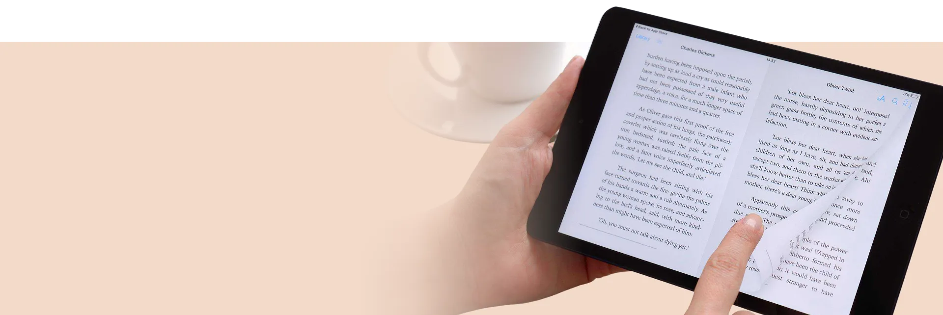 Self-publishing author workspace with books and tea